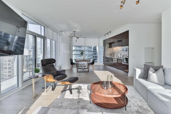 This picture of a chic, urban apartment with an open layout is a prime example of a property that benefits from wide exposure on various online travel agencies (OTAs). While the goal is to maximize occupancy, listing on multiple sites without a synchronized calendar results in double bookings. This image serves as a visual representation of the inventory that property managers are trying to sell, and the article explains how to use a reliable channel manager like Hostaway to manage it effectively to prevent booking conflicts