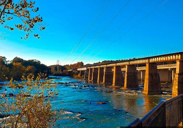 A scenic view of a bridge crossing the Congaree River in Columbia, South Carolina. This image captures the natural beauty of the area, which attracts tourists and short-term rental guests to the region. Columbia's STR regulations help balance tourism growth with neighborhood preservation.