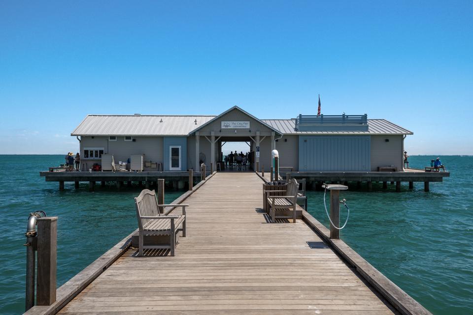 Anna Maria Island, a Hostaway client. A charming wooden bridge crossing calm waters on Anna Maria Island, Florida, capturing the island’s peaceful and natural beauty.